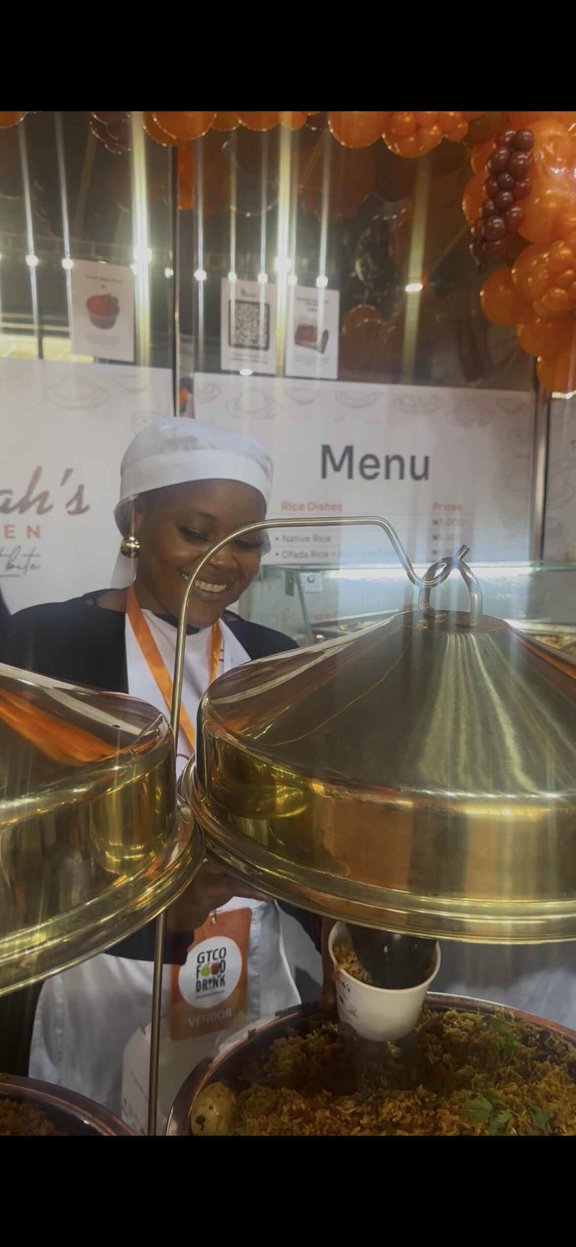 Rita behind the serving pots at the stand